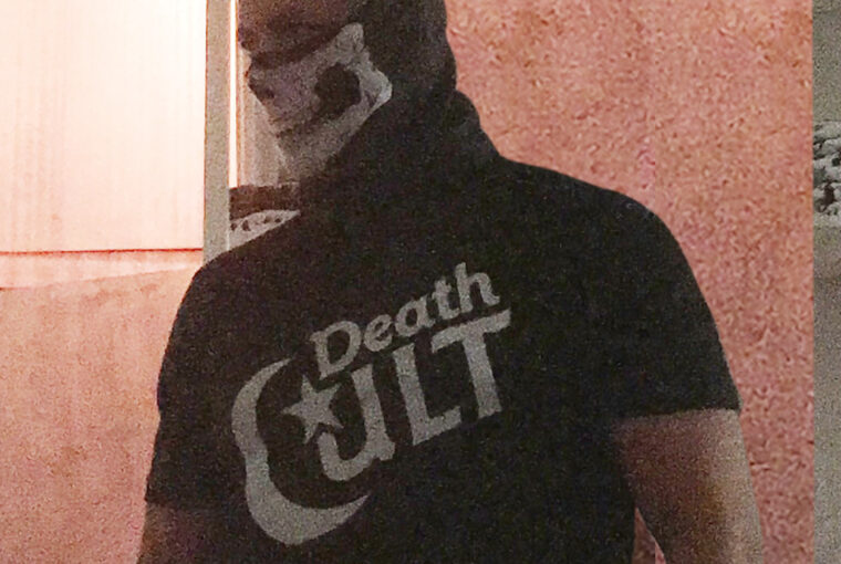 A man with a beard and a death cult t-shirt.