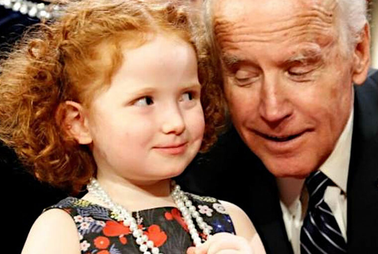 A little girl and an older man are smiling.