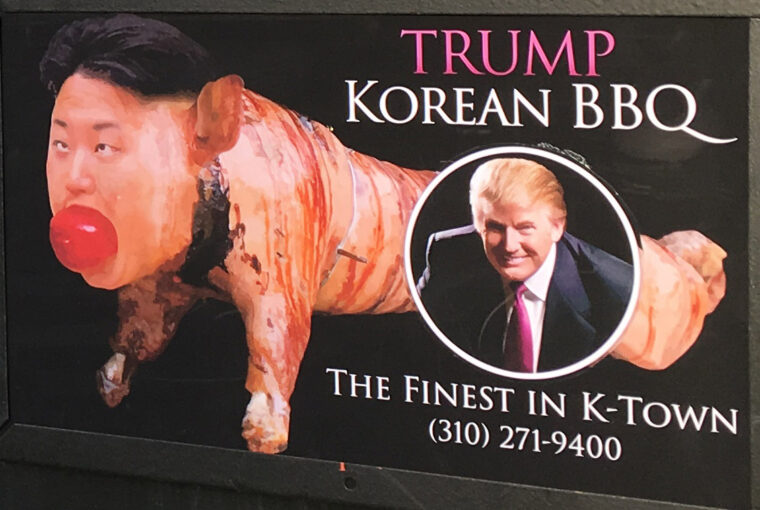 A billboard with a picture of donald trump and the words " trump korean bbq ".
