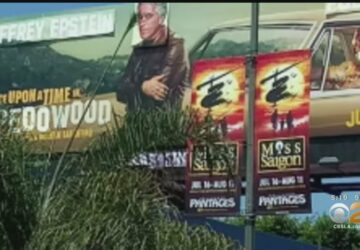 A billboard with a man on it and some bushes