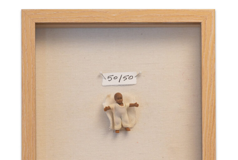 A picture of a person in a frame with the price tag 5 0 / 5 0.