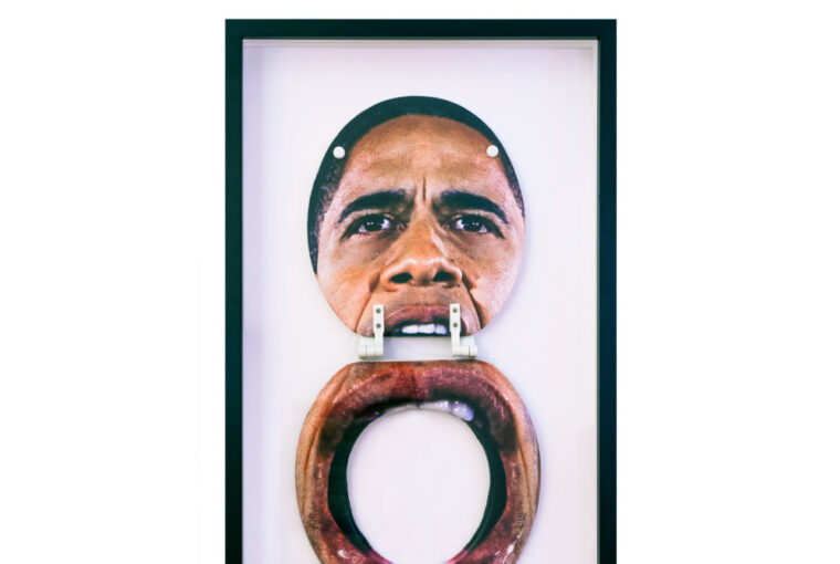 A picture of obama with a wooden ring.