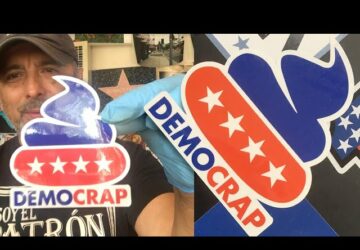 A person holding up some political signs