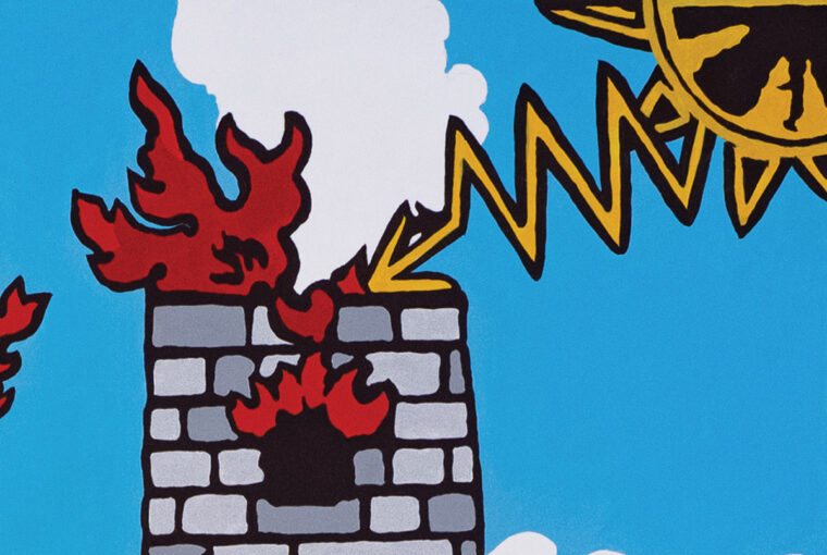 A fire is burning on the side of a building.