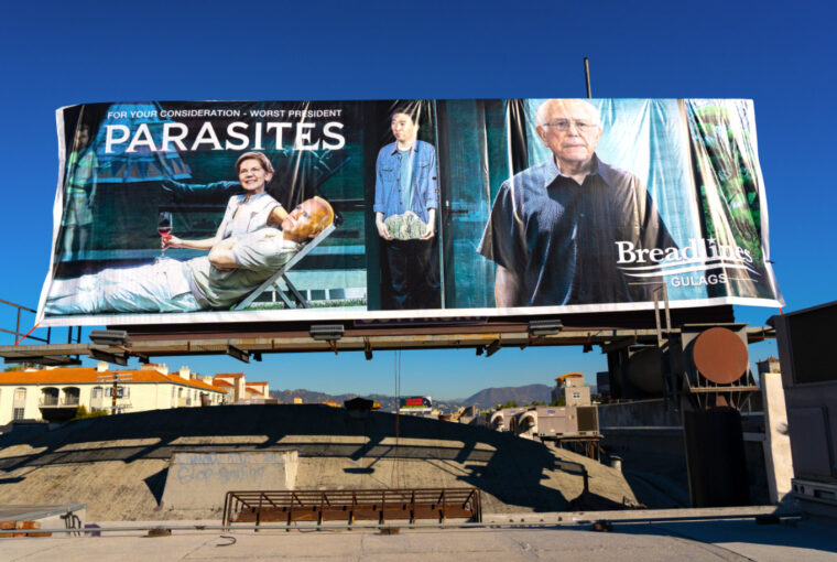 A billboard with two people and one man on it.