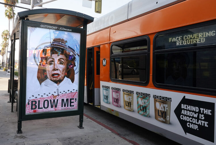 A bus with a poster on the side of it