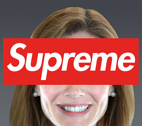 A woman wearing a white necklace with the word " supreme " on it.