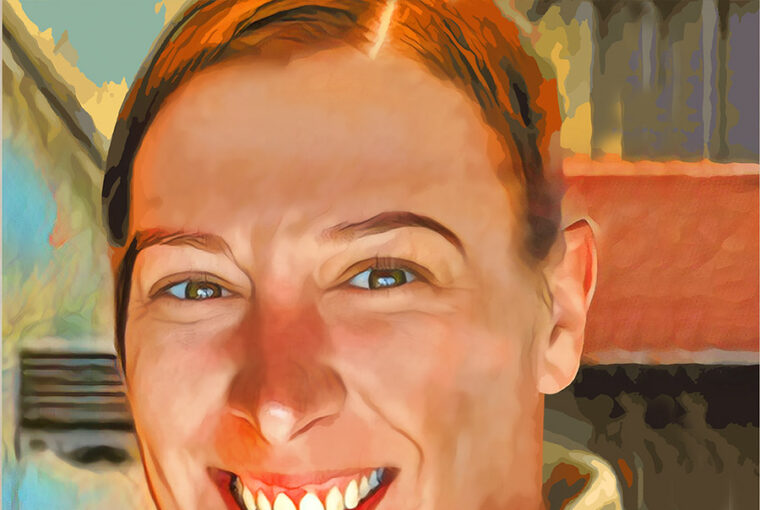 A woman smiling for the camera with her teeth.