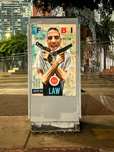 A poster of president obama with two guns in his hands.